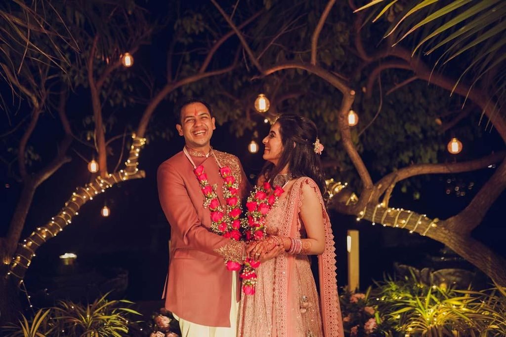 Candid Indian engagement couple sharing a happy moment together