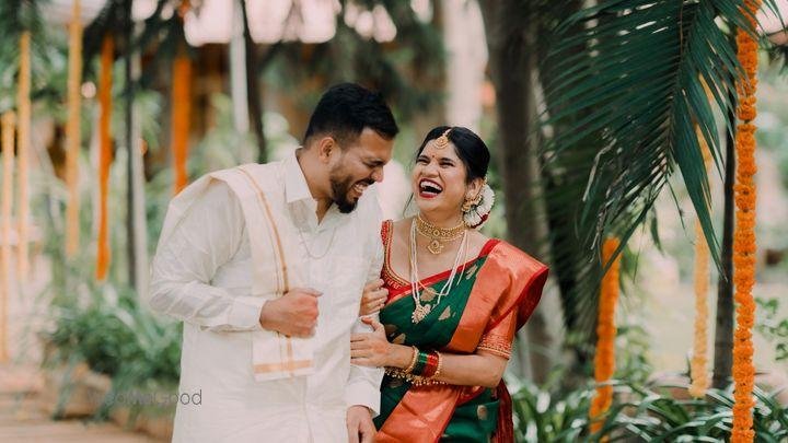 Candid South Indian bride and groom laughing together at their wedding