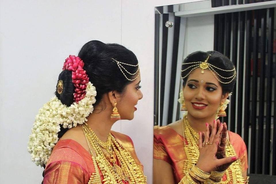Indian bride in traditional saree looking into a mirror