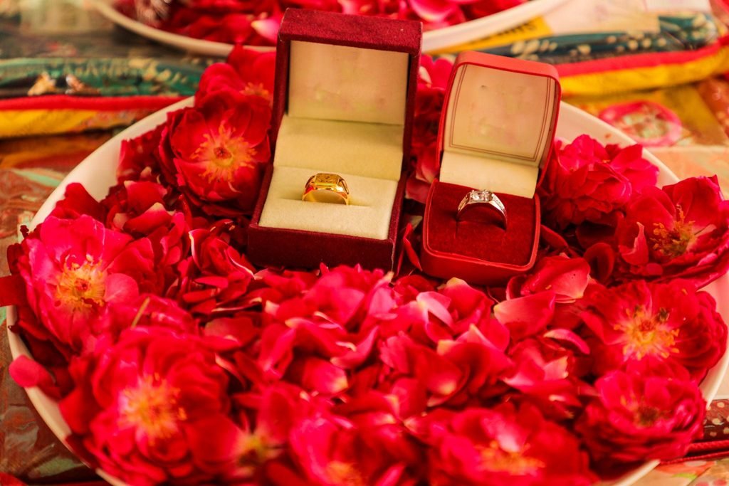 Engagement rings displayed with traditional Indian jewellery and flowers