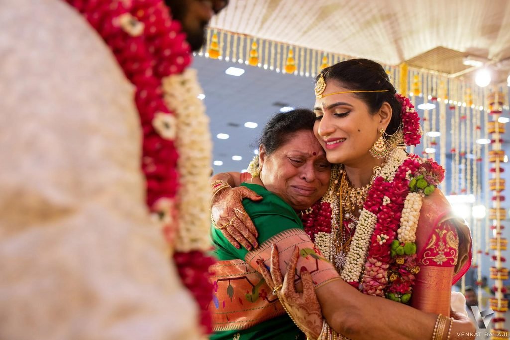 South Indian bride receiving blessings from her parents during the wedding